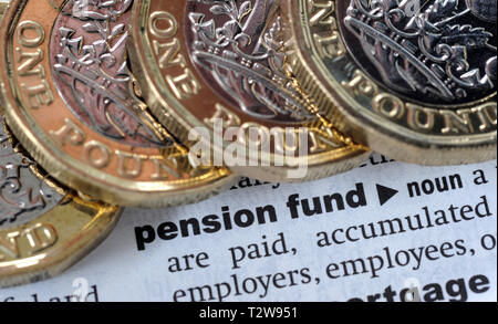 DICTIONARY DEFINITION OF PENSION FUND WITH ONE POUND COINS RE PENSIONS TAX HMRC ETC UK Stock Photo