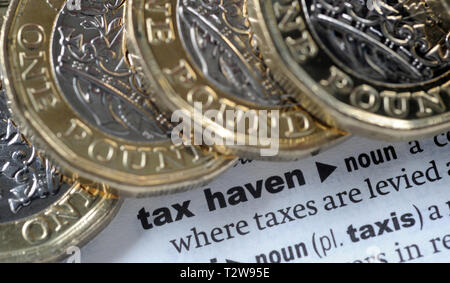 DICTIONARY DEFINITION OF  TAX HAVEN WITH ONE POUND COINS RE PENSIONS TAX HMRC ETC UK Stock Photo