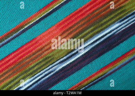 Diagonal Patterns and the Texture of Turquoise Blue with Red and Green Striped Alpaca Knitted Wool Fabric Stock Photo