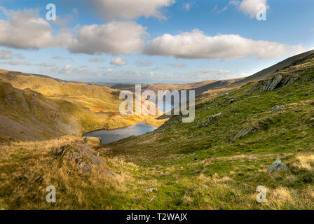 The view of Small water tarn and Haweswater reservoir with Piot crag to the left viewed from the top of the Nan Bield pass on Small water crag near Ha Stock Photo