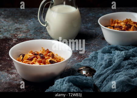 Two bowls of cornflakes on a dark gray background Stock Photo