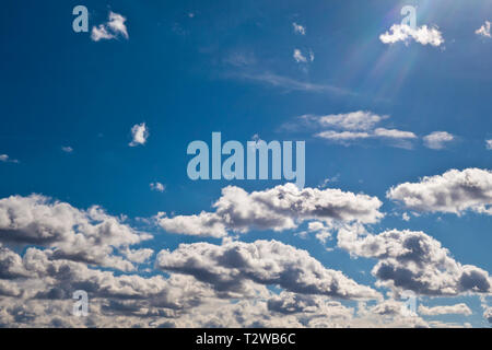 bright summer sky with white altocumulus clouds and rays of sun Stock Photo