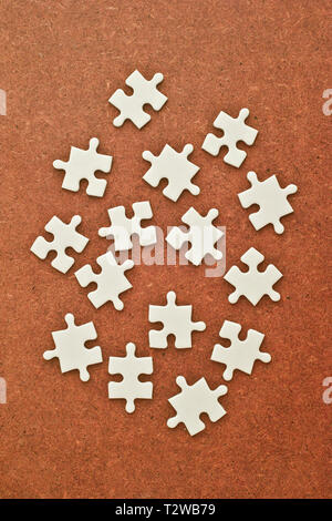 white jigsaw puzzle pieces scattered Stock Photo