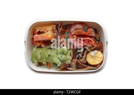 Frozen compost  with frosted vegetable scraps in container, isolated on white background Stock Photo