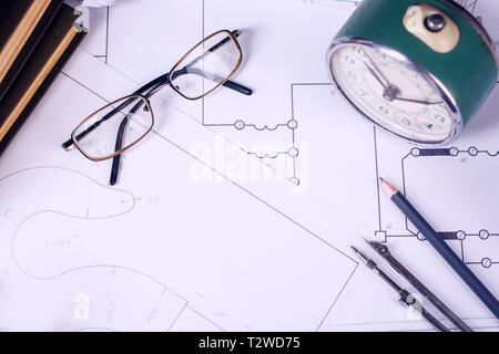 Several drawings and tools for drawing on the table in the engineer. compasses and blueprint Stock Photo
