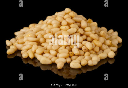 Pile of pine nuts isolated on black background with reflecton Stock Photo