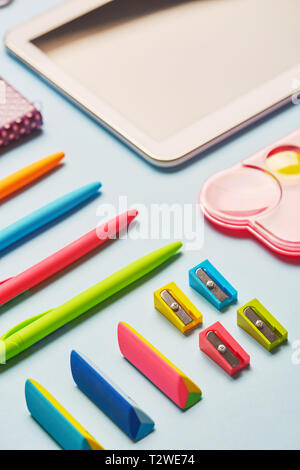 Bright gum, sharpeners and pens on a blue table. Composition lined with school supplies on a blue background Stock Photo