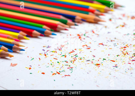 A group of bright wooden pencils on a white background. Abstract background from color pencils. Drawing supplies: assorted color pencils Stock Photo