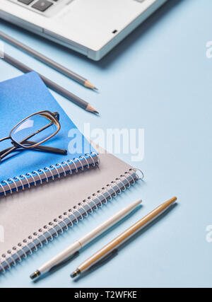 Notebooks, pencils, pens, glasses and computer are on the table. Working place elements. 1 September concept postcard Stock Photo