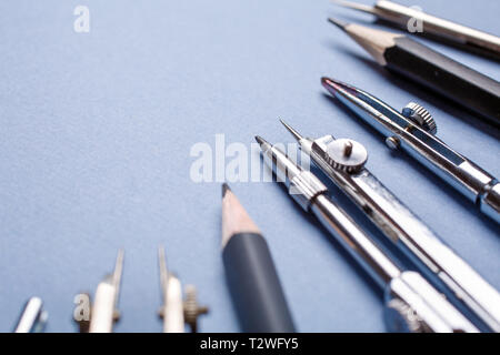 Compasses and pencils on a light blue background. 1 September concept postcard, teachers day. selective focus. Flat lay, place for text. Stock Photo