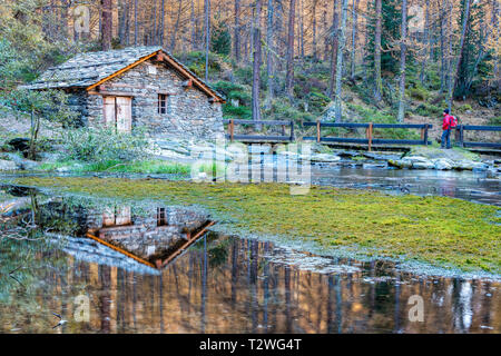 Italy, Aosta Valley, Rhemes Valley, Pellaud alpine lake, small hydroelectric plant (old watermill) Stock Photo