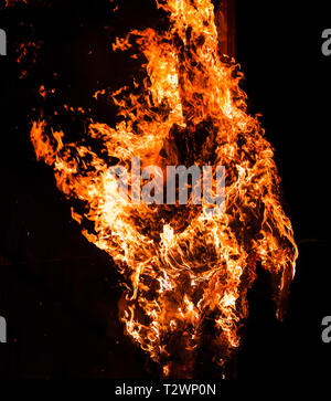 Big bonfire burns in the night over black background Stock Photo
