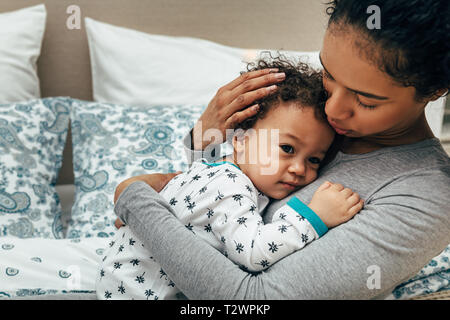 Mid section of mom carrying her baby at home Stock Photo