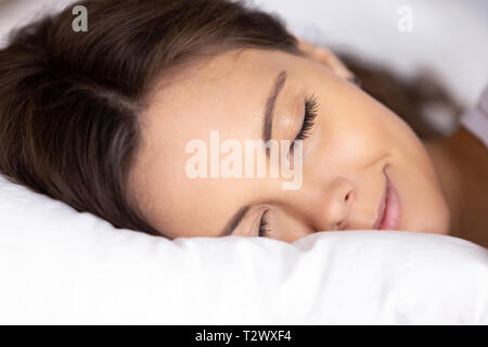 Closeup face of beautiful young woman sleeping on bed Stock Photo