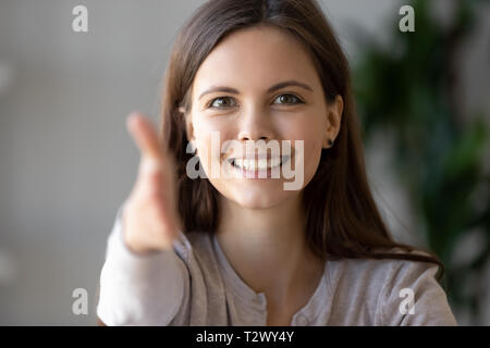 Young businesswoman holds out her hand to camera for handshake Stock Photo