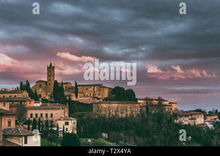 Sunset photo of Siena with hills and the castle, postcard with amazing colors Stock Photo