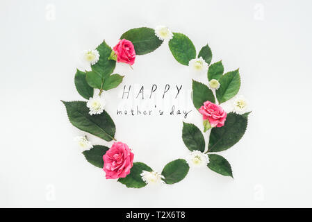 top view of circular composition with green leaves, roses and chrysanthemums on white background with happy mothers day illustration Stock Photo