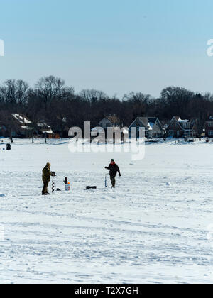 Ice fishing on Monona Bay, Madison, Wisconsin, USA. Stock Photo