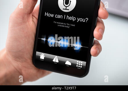 Person Using Voice Recognition Function On Mobile Phone Stock Photo