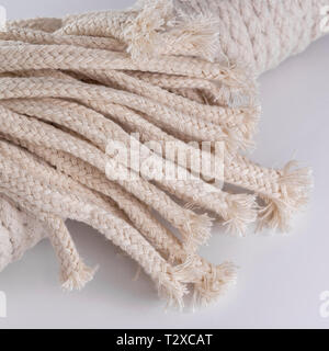 Macro close-up of unbleached diamond braided cotton spirit oil lamp wicks. Metaphor intertwines, weaving. Stock Photo