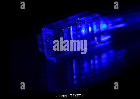 Network connection plug with fiber optics cable isolated on black background Stock Photo