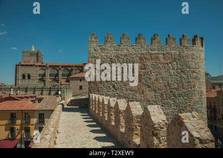 Stone thick wall with battlement, large tower and the Cathedral of Avila. With an imposing wall around the gothic city center in Spain. Stock Photo