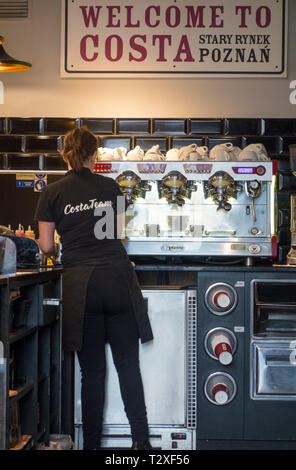 Barista making fresh coffee from a machine in a Costa coffee shop in the Polish city of Poznan Poland Stock Photo