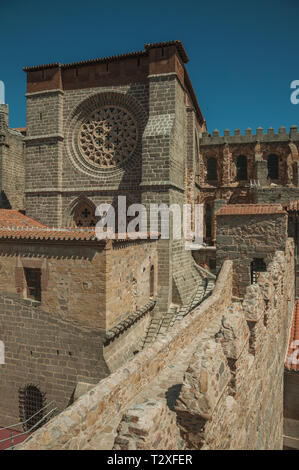 Stone thick wall with battlement and sidewall of the Cathedral of Avila. With an imposing wall around the gothic city center in Spain. Stock Photo