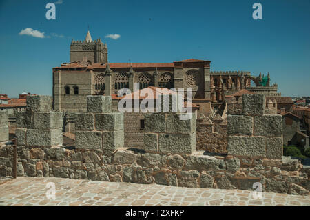 Stone thick wall with battlement and merlons next to the Cathedral at Avila. With an imposing wall around the gothic city center in Spain. Stock Photo