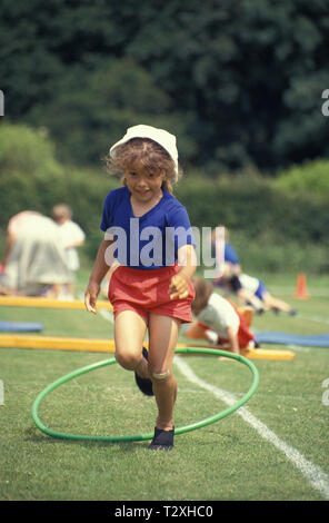 primary schoolgirl in obstacle race at school sports day Stock Photo