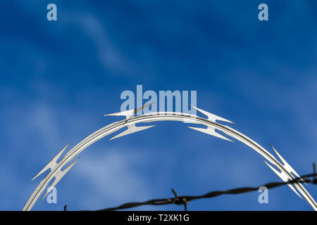 LAS VEGAS, NEVADA, USA - FEBRUARY 2019: Close up of coils of razor wire on a security fence around McCarran International Airport in Las Vegas. Stock Photo