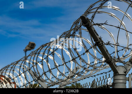 LAS VEGAS, NEVADA, USA - FEBRUARY 2019: Close up of coils of razor wire on a security fence around McCarran International Airport in Las Vegas. Stock Photo