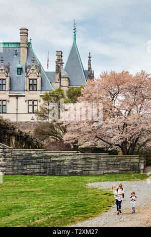A mother and two daughters walk on the path behind the Biltmore House in early spring, in Asheville NC, USA Stock Photo