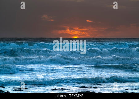 Sunset over a rough sea Stock Photo