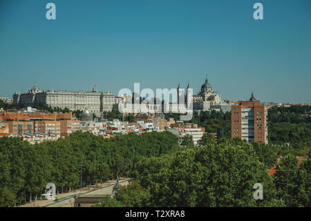 Landscape with the Royal Palace and Almudena Cathedral and trees from garden in Madrid. Capital of Spain with vibrant and intense cultural life. Stock Photo