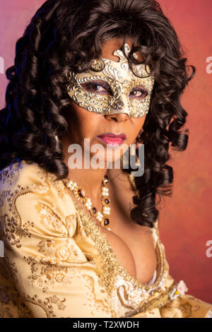 A middle aged, Puerto Rican, woman at a masquerade party. Stock Photo