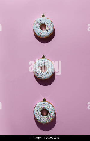 xmas decoration, donuts on a pink background Stock Photo