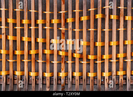 An unknown artist weaves golden ribbon through fence slats; Salida SteamPlant Event Center; Salida; Colorado; USA Stock Photo