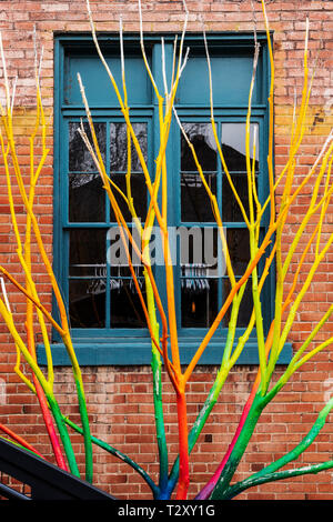 Artist Curtis Killorn hand paints tree vibrant colors, Steamplant Theater & Event Center, Salida, Colorado, USA Stock Photo