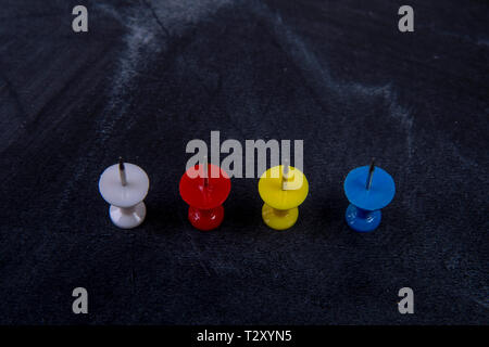 different coloured pins on a board Stock Photo