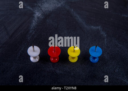 different coloured pins on a board Stock Photo