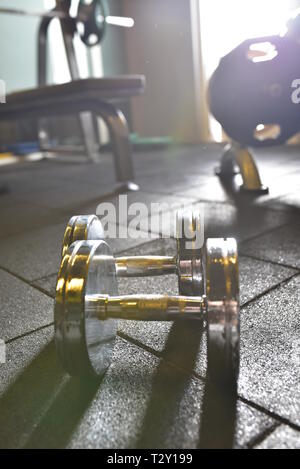 Dumbells on a black background at the Gym Stock Photo