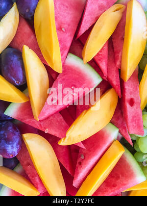 Watermelon, mango and plum fruit slices closeup Stock Photo