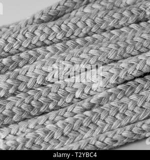 Macro close-up of unbleached diamond braided cotton spirit oil lamp wicks. Metaphor intertwines, weaving. Stock Photo