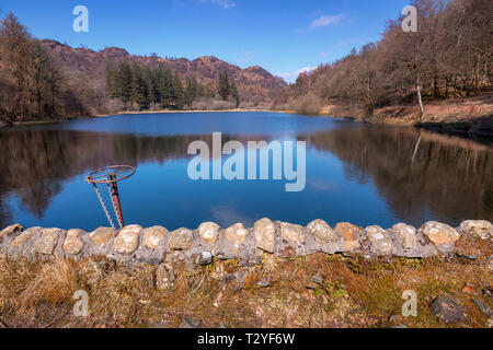 Yew Tree Tarn, One of the most accessable tarns – the road from Ambleside to Coniston goes right past it, with a small car park beside the tarn. Stock Photo