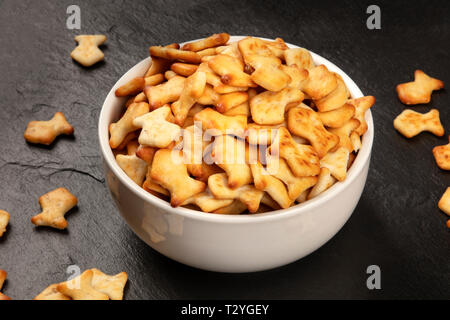 Goldfish crackers in a bowl on a black background Stock Photo