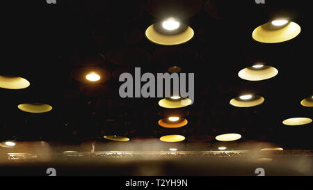 Spot lights and retro light bulbs in cinema hall on ceiling Stock Photo