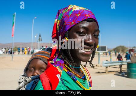 Local woman with child on the back, portrait, Opuwo, Kaokoland, Namibia Stock Photo