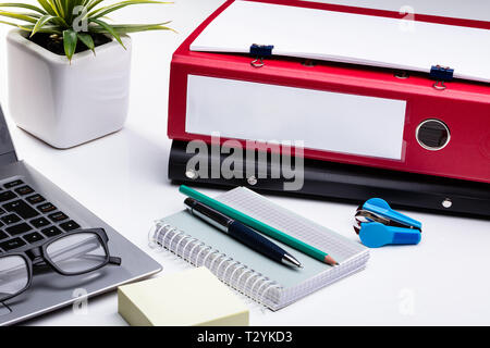 Office Workplace With Laptop And Folders On White Table Stock Photo