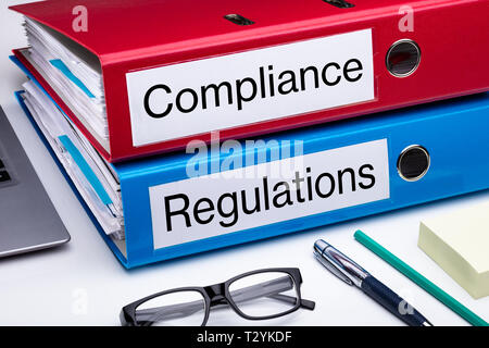 Compliance And Regulation With Office Supplies Over Business Desk Stock Photo